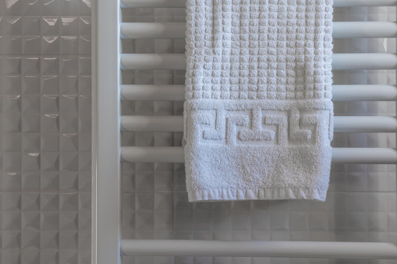 White Towel on White Wooden Rack